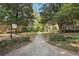 Exterior shot of condo complex showcasing landscaping, a walkway, and mature trees surrounding the property at 55 Delmont Ne Dr # D1, Atlanta, GA 30305