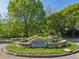 Historic Garden Hills entrance with lush greenery and stone signage at 55 Delmont Ne Dr # D1, Atlanta, GA 30305