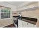 Functional kitchen with white cabinets, dark countertops, stainless steel appliances, and a window, offering a practical cooking space at 55 Delmont Ne Dr # D1, Atlanta, GA 30305