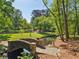 Stone bridge crossing a small pond in a lushly landscaped green space at 55 Delmont Ne Dr # D1, Atlanta, GA 30305