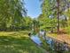 Tranquil view of a pond reflecting the trees and sky on a peaceful day at 55 Delmont Ne Dr # D1, Atlanta, GA 30305