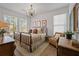 Charming bedroom with a metal frame bed, hardwood floors, and abundant natural light at 1004 Baldwin Dr, Milton, GA 30009