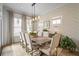 Elegant dining room with a farmhouse table, stylish lighting, and neutral decor at 1004 Baldwin Dr, Milton, GA 30009