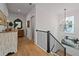 Bright hallway featuring hardwood floors, a decorative mirror, and modern lighting at 1004 Baldwin Dr, Milton, GA 30009