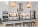 Modern kitchen featuring a large island with seating, stainless steel appliances, and elegant pendant lighting at 1004 Baldwin Dr, Milton, GA 30009