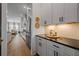 Well-lit kitchen with stainless steel refrigerator, white cabinets, and herringbone backsplash at 1004 Baldwin Dr, Milton, GA 30009