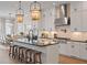 Modern kitchen featuring a large island with seating, stainless steel appliances, and elegant pendant lighting at 1004 Baldwin Dr, Milton, GA 30009