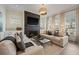 Cozy living room featuring a fireplace, comfortable sofas, and large windows at 1004 Baldwin Dr, Milton, GA 30009