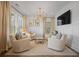 Bright living room featuring a chandelier, neutral colors and comfortable seating arrangements at 1004 Baldwin Dr, Milton, GA 30009