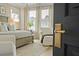 Luxurious main bedroom with a comfortable bed, accent chair, and natural light at 1004 Baldwin Dr, Milton, GA 30009