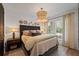 Comfortable bedroom with stylish lighting, textured headboard, side tables and neutral decor at 1004 Baldwin Dr, Milton, GA 30009