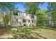 Backyard with a home exterior including wood stairs and a patio surrounded by mature trees at 1027 Mount Airy Sw Dr, Atlanta, GA 30311