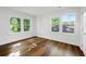 Bright bedroom featuring hardwood floors, white walls, and sun-filled windows with treetop views at 1027 Mount Airy Sw Dr, Atlanta, GA 30311