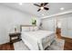 Bright bedroom with hardwood floors, neutral tones, a ceiling fan, and an ensuite bathroom at 1027 Mount Airy Sw Dr, Atlanta, GA 30311