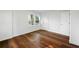 Bedroom with wood flooring, white trim, and two white doors leading to closets at 1027 Mount Airy Sw Dr, Atlanta, GA 30311