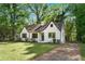 Charming white brick home featuring a well-manicured lawn and a curved roofline at 1027 Mount Airy Sw Dr, Atlanta, GA 30311