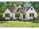 Charming white brick home featuring a well-manicured lawn and classic architectural details at 1027 Mount Airy Sw Dr, Atlanta, GA 30311