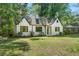 Charming white brick home featuring a well-manicured lawn and classic architectural details at 1027 Mount Airy Sw Dr, Atlanta, GA 30311