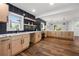 Spacious kitchen with light wood cabinets, granite countertops, and sleek black backsplash at 1027 Mount Airy Sw Dr, Atlanta, GA 30311