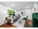 Bright living room features hardwood floors, comfortable seating, and a decorative fireplace at 1027 Mount Airy Sw Dr, Atlanta, GA 30311