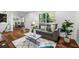Inviting living area with hardwood floors, a gray sofa, and a sun-filled window at 1027 Mount Airy Sw Dr, Atlanta, GA 30311