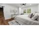 Spacious bedroom with hardwood floors, ceiling fan, a decorative rug, and large window overlooking front yard at 1027 Mount Airy Sw Dr, Atlanta, GA 30311