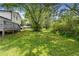 A spacious backyard with green grass and large trees, perfect for outdoor activities and relaxation at 3107 Park Ln, Snellville, GA 30078