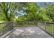 Charming grey backyard deck surrounded by lush greenery and trees offering a peaceful space to enjoy the outdoors at 3107 Park Ln, Snellville, GA 30078