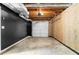 Spacious unfinished basement with exposed ceiling features, painted walls, and a garage door at 3107 Park Ln, Snellville, GA 30078