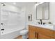Well-lit bathroom featuring shower and tub, a single vanity, and a mirror at 3107 Park Ln, Snellville, GA 30078