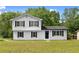 Charming two-story home with white siding, black shutters, and a well-manicured lawn at 3107 Park Ln, Snellville, GA 30078