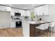 Modern kitchen featuring white cabinets, stainless steel appliances, and a breakfast bar at 3107 Park Ln, Snellville, GA 30078