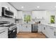 Contemporary kitchen boasting white cabinetry, stainless appliances, and quartz countertops at 3107 Park Ln, Snellville, GA 30078