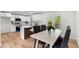 Stylish kitchen with white cabinets, stainless steel appliances, and a dining area at 3107 Park Ln, Snellville, GA 30078