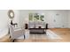 Inviting living room featuring hardwood floors, a cozy sofa, and contemporary decor at 3107 Park Ln, Snellville, GA 30078