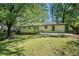 Exterior view of the house from the backyard showing the outdoor patio and green grass at 3200 Rehoboth Dr, Decatur, GA 30033