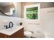 Stylish bathroom with modern vanity, sleek black hardware, white tile, and a large window view at 3200 Rehoboth Dr, Decatur, GA 30033
