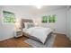 Serene bedroom with hardwood floors, bright windows, and a comfortable bed with neutral bedding at 3200 Rehoboth Dr, Decatur, GA 30033