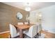 Elegant dining room featuring hardwood floors, a statement wallpaper, and a stylish light fixture at 3200 Rehoboth Dr, Decatur, GA 30033