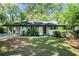 Charming brick home with a well-manicured lawn, covered car port, and inviting curb appeal at 3200 Rehoboth Dr, Decatur, GA 30033