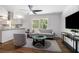 Inviting living space featuring a modern ceiling fan, contemporary furniture, and a view into the adjacent kitchen at 3200 Rehoboth Dr, Decatur, GA 30033