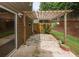 The tiled back patio features a pergola, plants and a privacy fence for seclusion and relaxation at 5260 Sherwood Way, Cumming, GA 30040