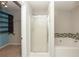 Bathroom with shower, tub, and closet storage at 5260 Sherwood Way, Cumming, GA 30040