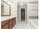 Bathroom with double vanity, bathtub, shower, and a walk-in closet in view at 5260 Sherwood Way, Cumming, GA 30040