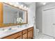 Bathroom featuring a double sink vanity, a large mirror, and tiled floors at 5260 Sherwood Way, Cumming, GA 30040