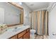 Bathroom with a vanity, toilet, shower with curtain, and a well-lit mirror at 5260 Sherwood Way, Cumming, GA 30040