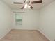 Bright bedroom featuring a ceiling fan, carpeted floors, and window at 5260 Sherwood Way, Cumming, GA 30040