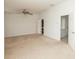 Large bedroom with a ceiling fan, carpeted floors, and white walls at 5260 Sherwood Way, Cumming, GA 30040