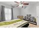 Bedroom with a ceiling fan, natural light from the window, and modern decor at 5260 Sherwood Way, Cumming, GA 30040