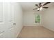Carpeted bedroom with ceiling fan and a window at 5260 Sherwood Way, Cumming, GA 30040